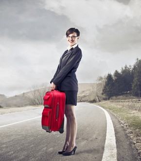 Business woman leaving with a red suitcase